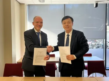 Dean Professor Volker and Dead Professor Zhou Changjun shaking hands and smiling