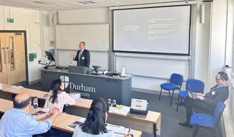 A man presenting in front of a powerpoint