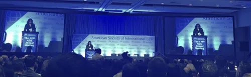A woman at a podium at the American Society of International Law Annual Meeting