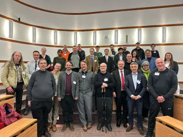 Around 30 people smiling at the camera