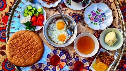 Selection of foods and drinks from across the Muslim World on a patterned table cloth.