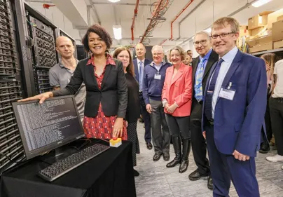 Photo of Chi Onwurah and various University academics posing with the new supercomputer