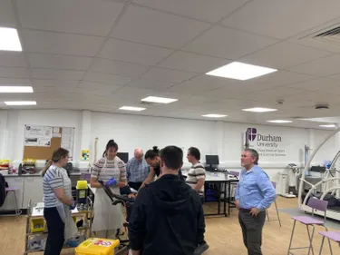 A number of individuals taking part in experimental lab work