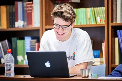 Student working on a laptop in the library