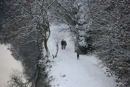 Couple walking through heavy snow by the River Wear