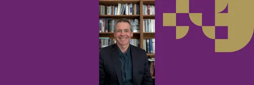 Professor Grant Macaskill is pictured against a background of books