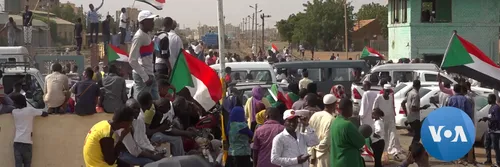 Protestors take to the streets in Sudan, waving Sudanese flags
