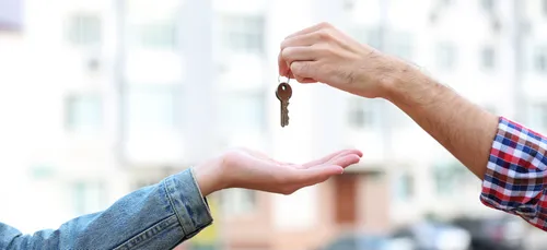 one person giving another person a key