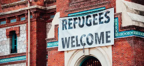 refugees welcome sign placed on building