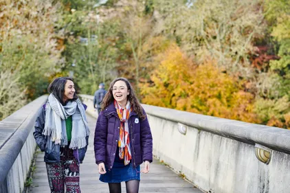 Students on Kingsgate bridge in autumn