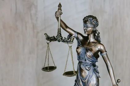 Blindfolded woman holding justice scales