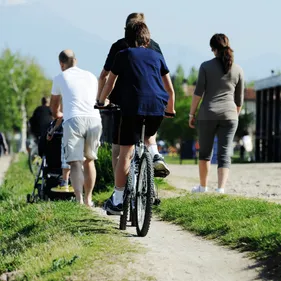 People walking and cycling along a pathway looking from behind
