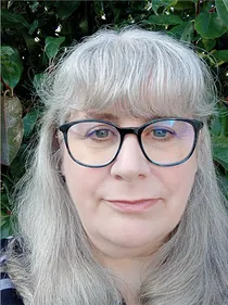 A woman with a fringe and glasses