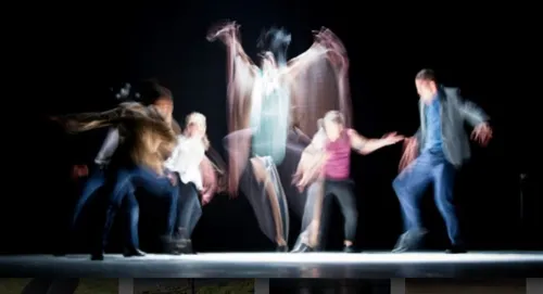 A blurred collection of figures dancing