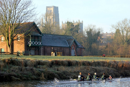 River in the forefront with rowers and Cathedral in the background