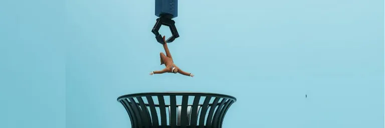 Graphic drawing of a robotic hand dropping a worker into a waste bin
