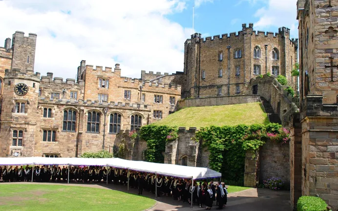 The Keep of Durham Castle from the Courtyard, on the right is the Gatehouse, at the top right is the Keep and then on the left the Tunstall Gallery, Chapel and Tower, with students gathered in the Courtyard