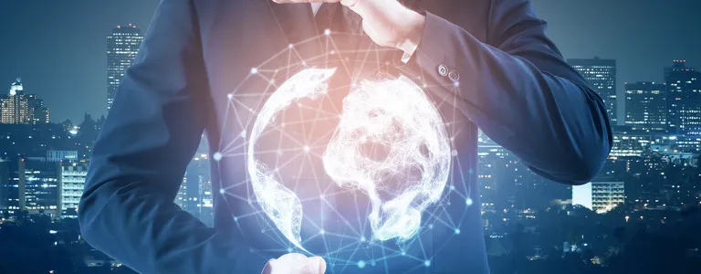 Man holding abstract glowing globe with a blurry city background