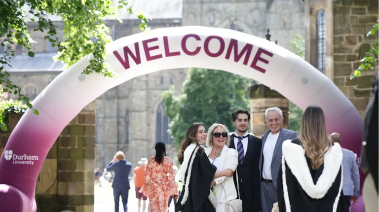 Students and parents at congregation under welcome sign