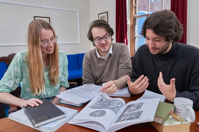 A group of people looking at books