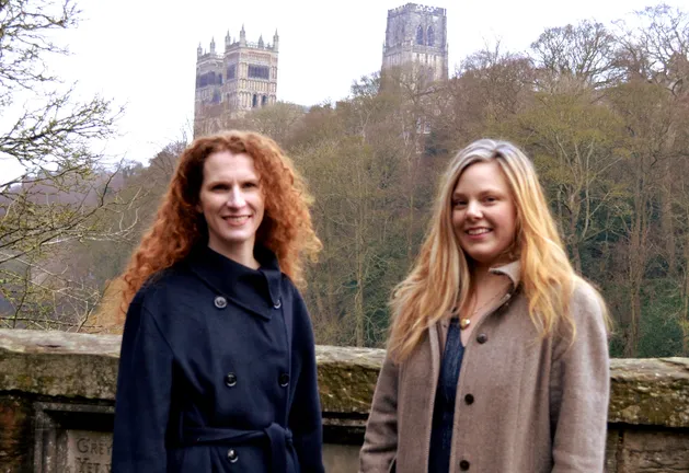 The legacies team stand on Prebends Bridge with Durham Cathedral behind them