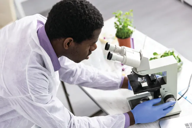Man looking through microscope