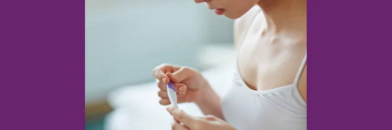 Young woman with pregnancy test in hands