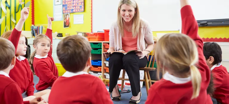 Teacher with pupils sat on the floor