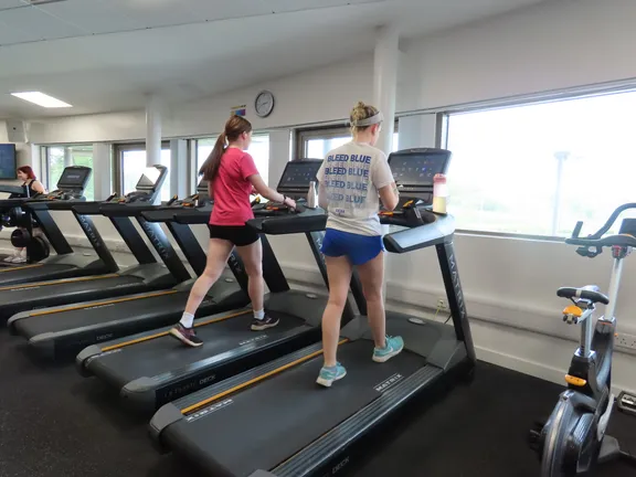 Two students running at The Hub Gym