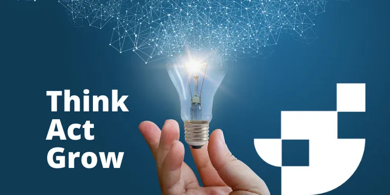 A hand holding a lightbulb with the words think, act, and grow written down the side.