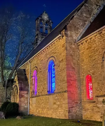 chapel with coloured lights in windows