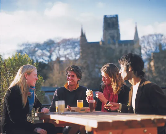 Students sitting with Durham Cathedral in the background