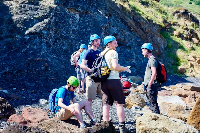 Group of people with hard helmets talking