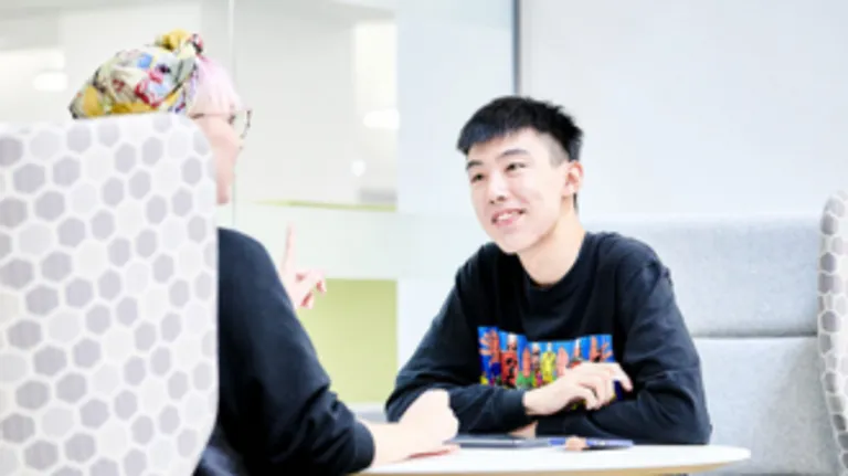 A male and female student facing eachother.