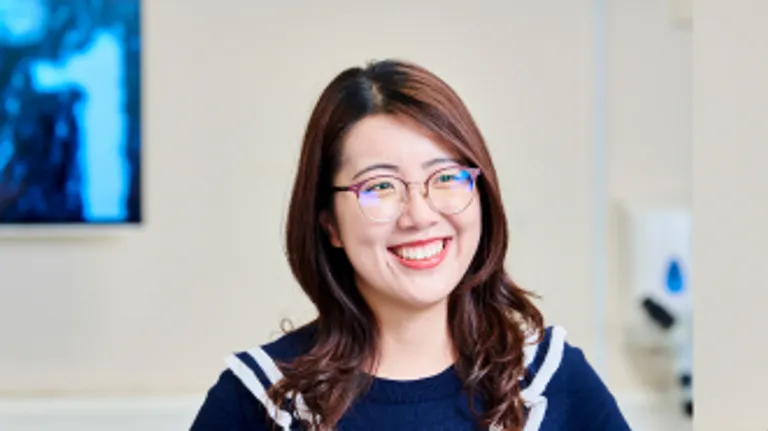 Picture of a female student wearing glasses and smiling.