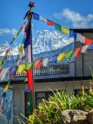 Prayer flags with a mountain behind them