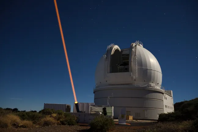 Orange laser guide star unit outside WHT telescope