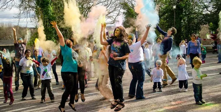 People throwing coloured power to celebrate Holi at the Oriental Museum