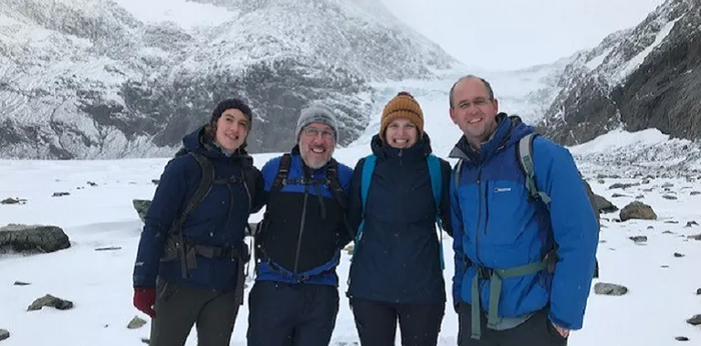 Four people posing and smiling