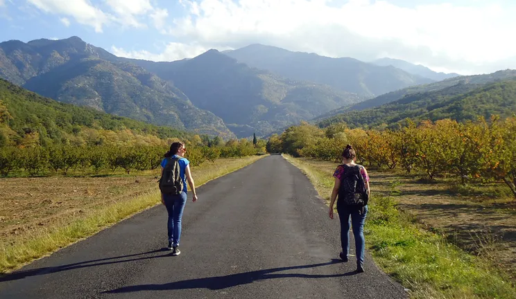 Two students walking along a road in the Prades Mountains, Spain