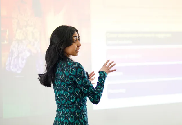 Research presenting in front of a large screen