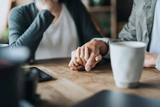 people holding hands - image courtesy of iStock