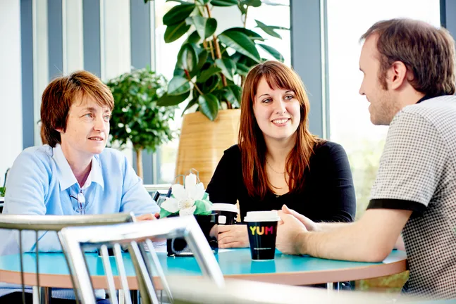 Three people talking