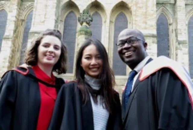 Group of smiling graduates outside Cathedral