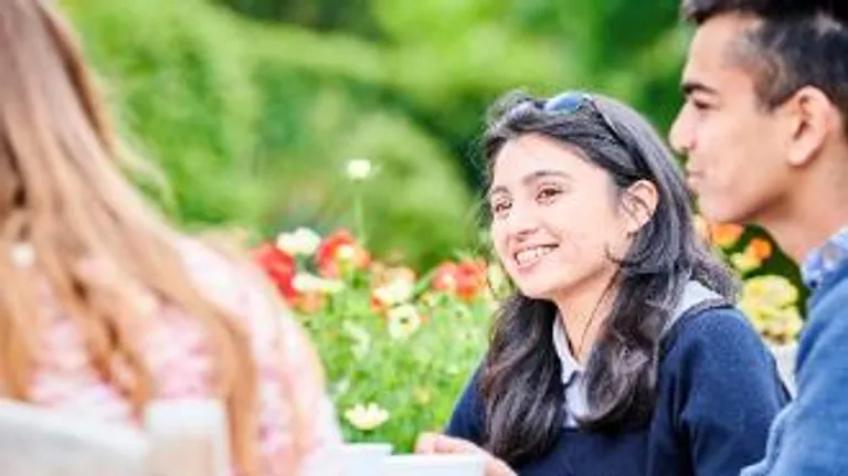 Students at a table in the botanic garden