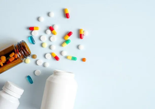 Pill bottles and pills on a blue background