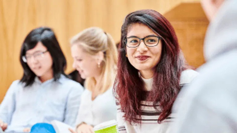 Student smiling with students in the background