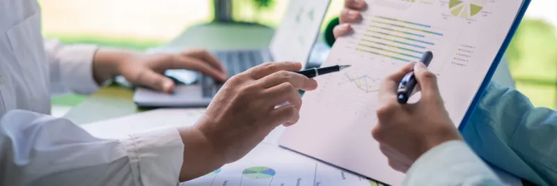 Reviewing sustainability reports in business meeting
