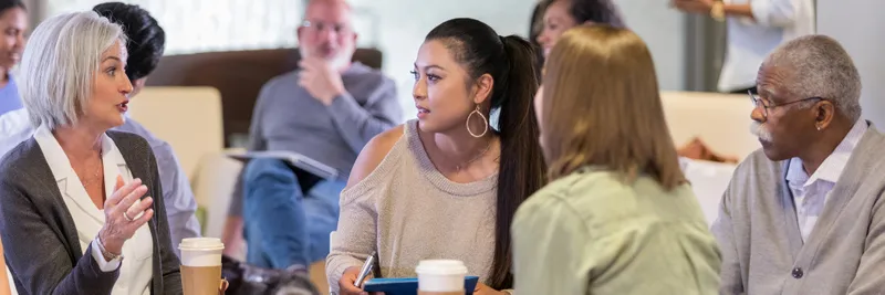 Mature caucasian female facilitates a group session