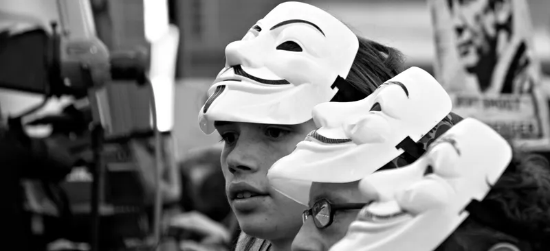 Protestors wearing masks in support of Julian Assange in 2012